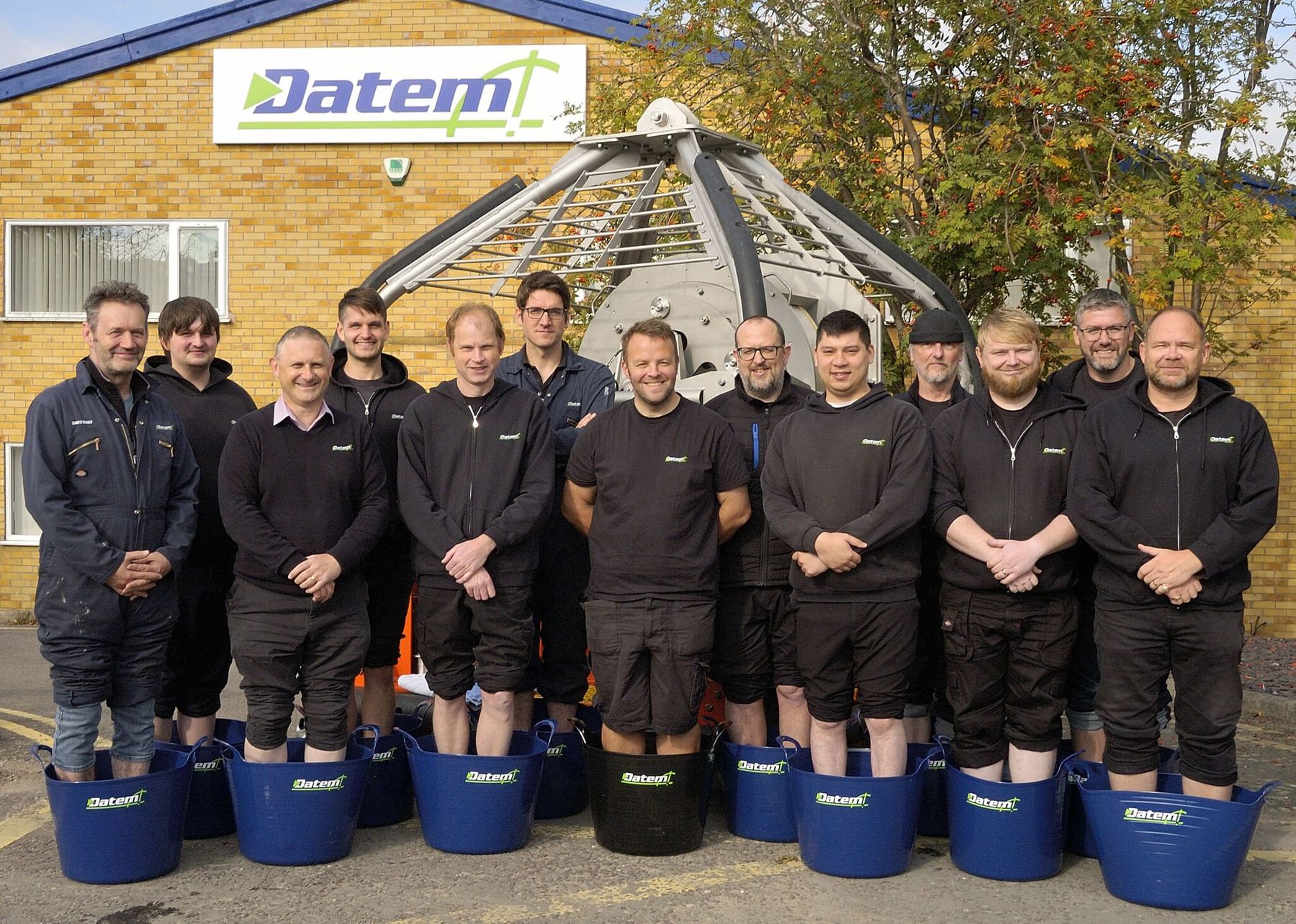 The Datem team standing in buckets of cold water for National Daily Dip 4 Dave Day