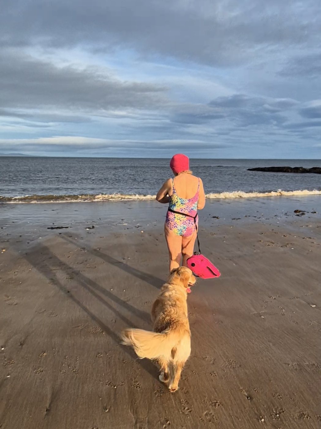 Ruth walking into the sea with her dog