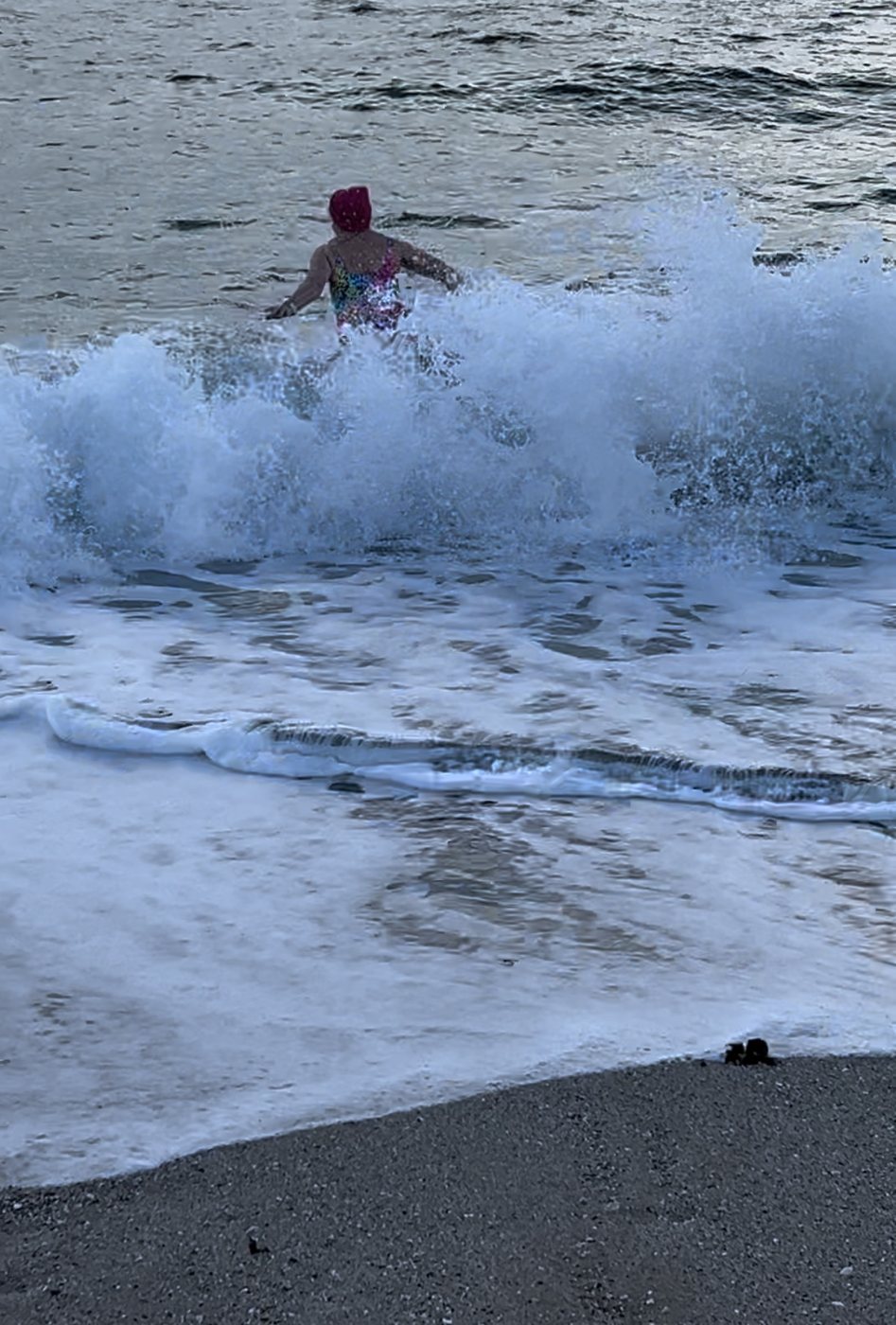 Ruth wading into a big wave