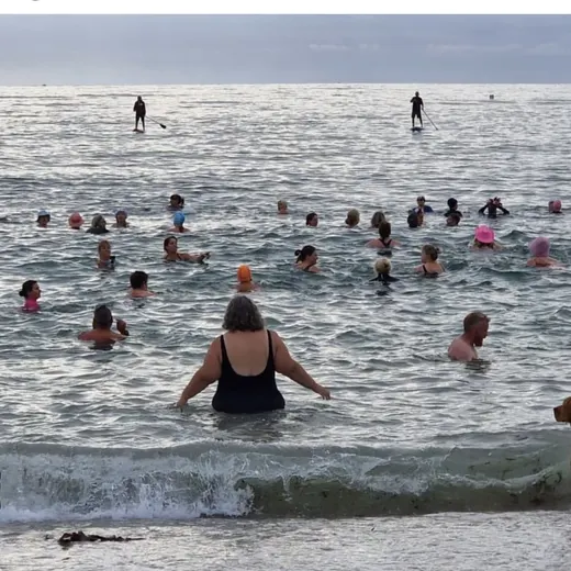 Dozens of swimmers in the sea together